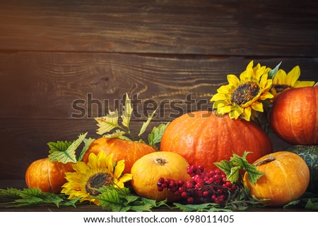Happy Thanksgiving Day background, wooden table, decorated with vegetables, fruits and autumn leaves. 