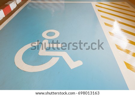 Disabled parking symbol, a free area for people with disabilities to use the service in the parking lot of the building.
