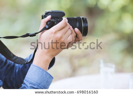 Young man is photographed with dslr camera