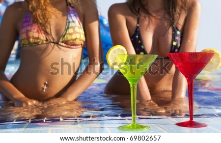 Two beautyful  women enjoying teir summer vacation with a glasses of martini