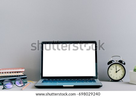 Laptop with blank screen on table in home studio, vintage tone