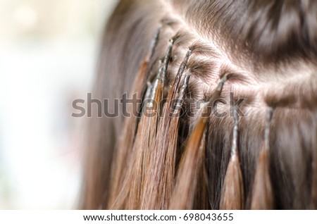 Properly upgrading hair, row and column pinched by keratin and microring Royalty-Free Stock Photo #698043655