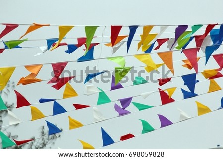Multi-colored buntings hanging out in the air for a celebration