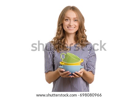 Beautiful young girl in the hands of a plates on a white background isolation