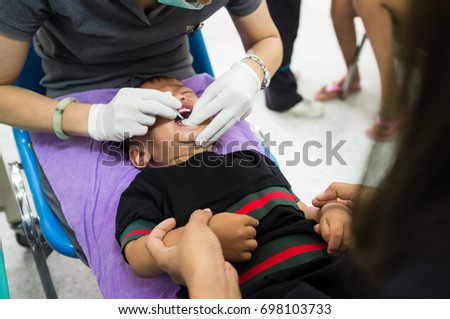 
The little boyl on reception at the doctor receives the polio vaccine, a child being treated for influenza, the child takes the medicine in the hospital
 Royalty-Free Stock Photo #698103733