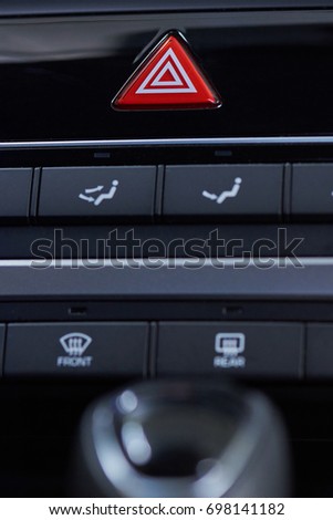 Emergency light button  in car interior. Red accident button