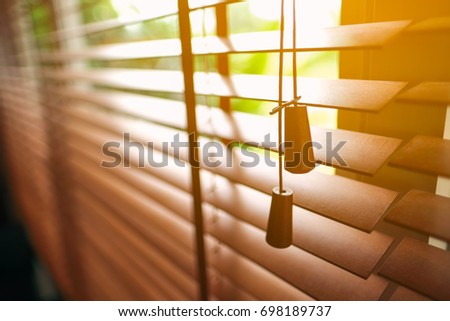 Wooden blinds with sun light.