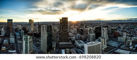 Aerial Drone Sunset Panorama - Skyline of the city of Denver, Colorado.  Rocky Mountains are on the horizon.  
