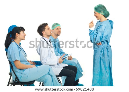 Surgeon woman havinf discussion with her colleagues dosctors  at a seminar isolated on white background