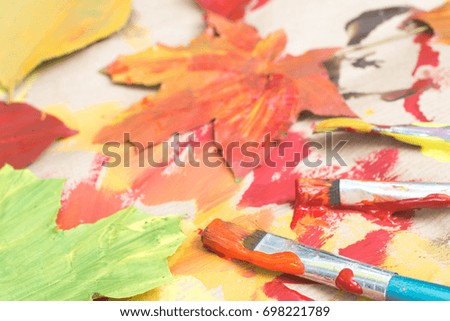 painted autumn leaves on brown paper