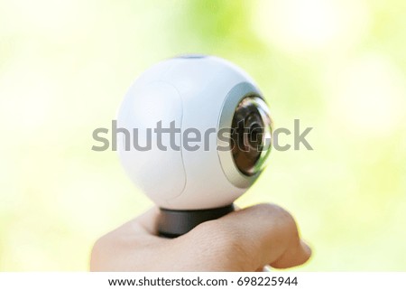 Close up picture of a 360 degree panoramic virtual tour camera in human hand outdoor