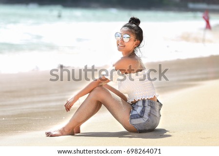 Asian girl by the sea in phuket beach.