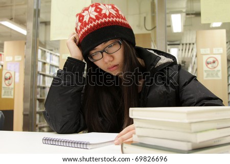 A Chinese girl who is studying hard in library
