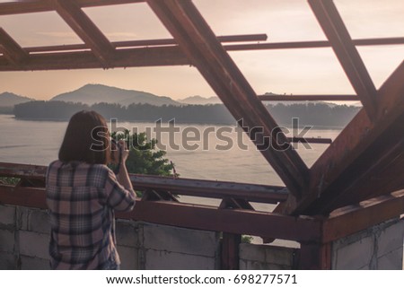 Woman Put on a shirt plaid pattern. trip, sea photograph in Phuket, Thailand morning light