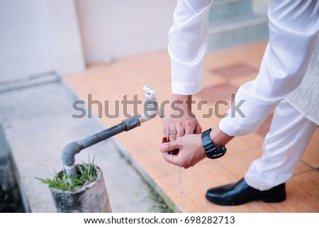Man wash his hand before his wedding day