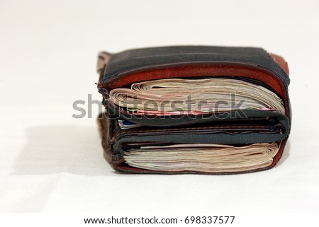 Close up of One black purse with the big pack of dollars