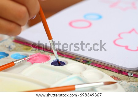 close up  hand  art kid paint watercolor paper for education background 