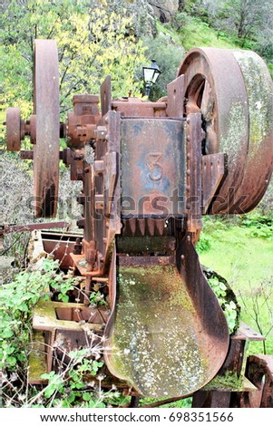 metaphor of abandonment, old age, death, oblivion,Old abandoned machine next to the river Tagus in Toledo,visual allegories, visual metaphors, photographic allegories, photographic metaphors,
