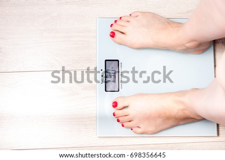 Female bare feet standing on a digital scales. Weight loss