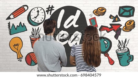 Digital composite of Business people looking at white wall with graphics