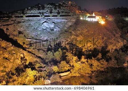 Night photography of the cliffs of the river Tagus in Toledo, with the church of virgen of the valley,