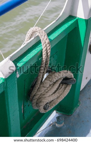 A thick brown rope hangs on the ship