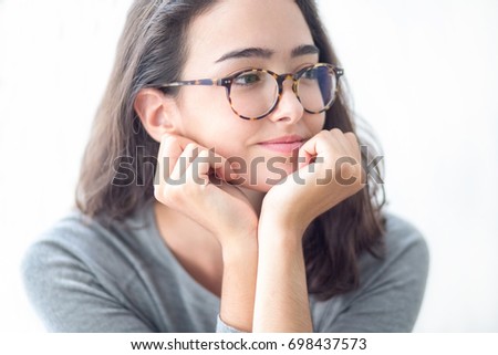 Smiling teenage girl in glasses looking away