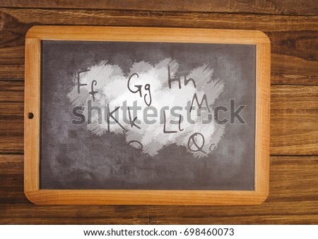 Digital composite of letters on blackboard