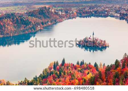 Aerial view of church of Assumption of Maria on the Bled lake. Foggy autumn landscape in Julian Alps, Slovenia, Europe. Beauty of countryside concept background.
