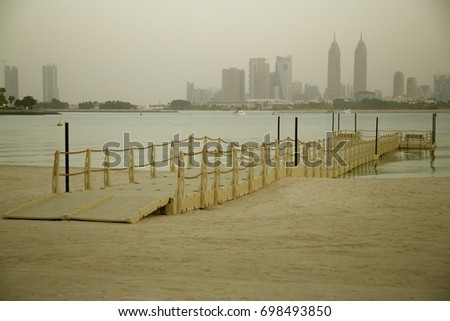 Wooden bridge on the sea water. Dubai Marina