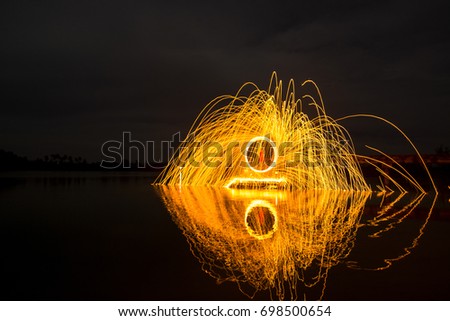 beautiful reflection of spinning fire wool 