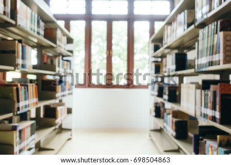 Abstract blur and defocused bookshelf in library interior for background