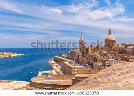 View from above of the golden domes of churches and roofs with church of Our Lady of Mount Carmel and St. Paul's Anglican Pro-Cathedral, Valletta, Capital city of Malta