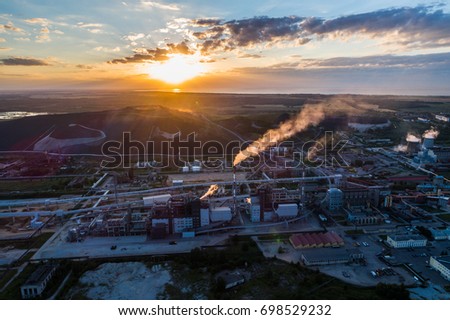 Aerial view Oil refinery with a background of mountains and sky at sunset. Aerial photography.