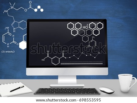 Digital composite of Computer Desk foreground with blackboard graphics of science diagrams