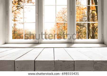 White table on the background of a white autumn afternoon window