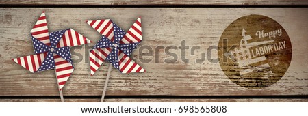 Digital composite image of happy labor day text on blue poster against wood panelling