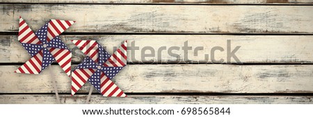 3D image of pinwheel toy with American flag pattern against wood panels in row