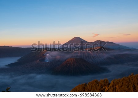 Mount Bromo volcano during sunrise, the magnificent view of Mt.Bromo located in Bromo Tengger Semeru National Park, East Java, Indonesia, Kingkong Hill viewpoint, Penajakan Royalty-Free Stock Photo #698584363