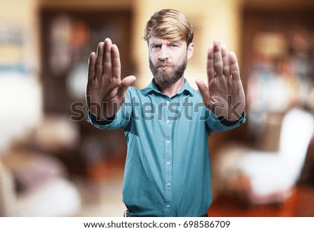 young blonde man stop sign. surprised expression