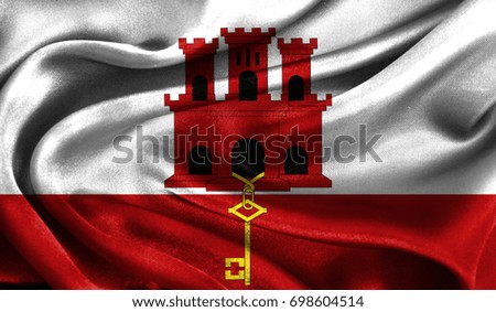 Realistic flag of Gibraltar on the wavy surface of fabric. This flag can be used in design
