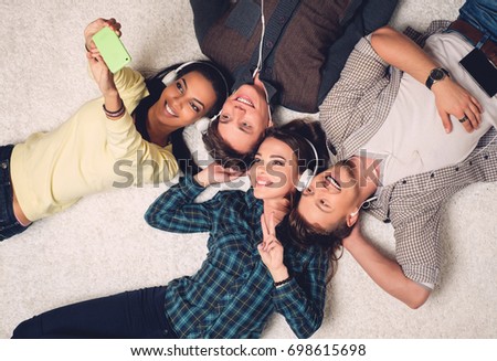 Happy multiracial friends taking selfie