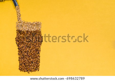 Creative drawing made with barley malt, filling faucet made up of beer. Royalty-Free Stock Photo #698632789