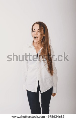 young slim girl in autumn coat. office worker in a shirt and trousers. posing in Studio on white background paper. Wallpapers for your desktop. long hair and clean skin