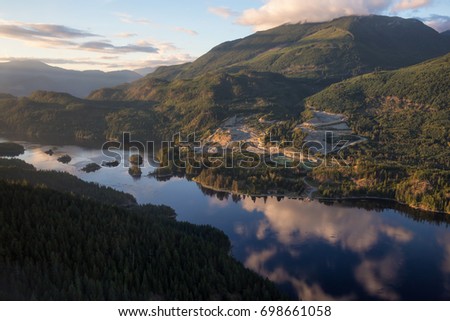 Aerial view of Skookumchuck Narrows and a Mining Industrial site. Picture taken from an airplane in Sunshine Coast, Northwest of Vancouver, British Columbia, Canada, during a sunny summer sunset.