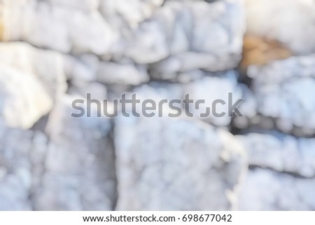 Blurred image of stones located on the mountainside. Abstract background.