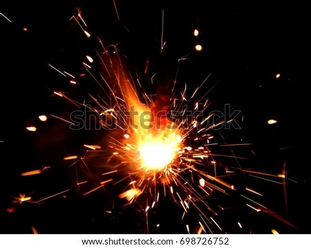 Sparklers with sparks on a black background Royalty-Free Stock Photo #698726752