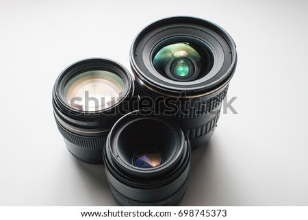 close-up view of a group of camera lenses on a white surface