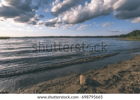 View of a comfortable coast beach in the sunset in summer. - vintage film look