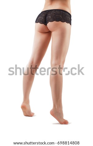 Long beautiful female legs in black panties. Isolated on white